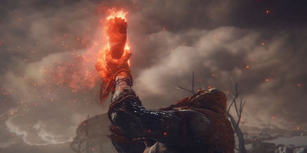 The Fire Giant offers his leg to the Fell God in Elden Ring boss fight