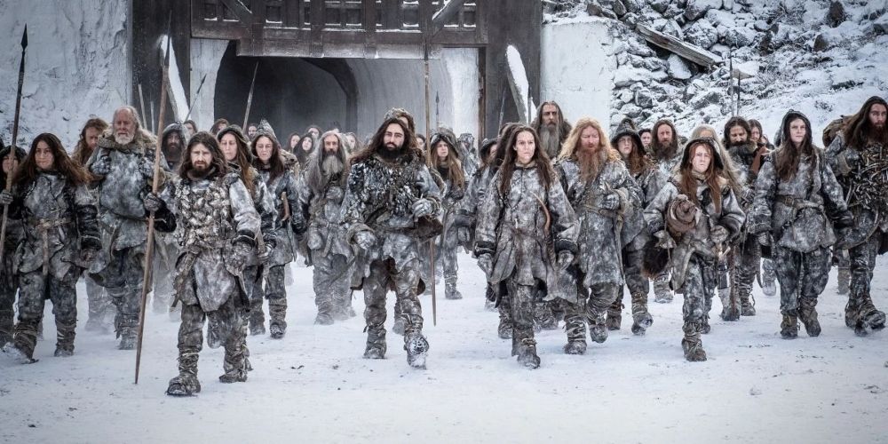 A group of Free Folk moving through the Wall in Game of Thrones.