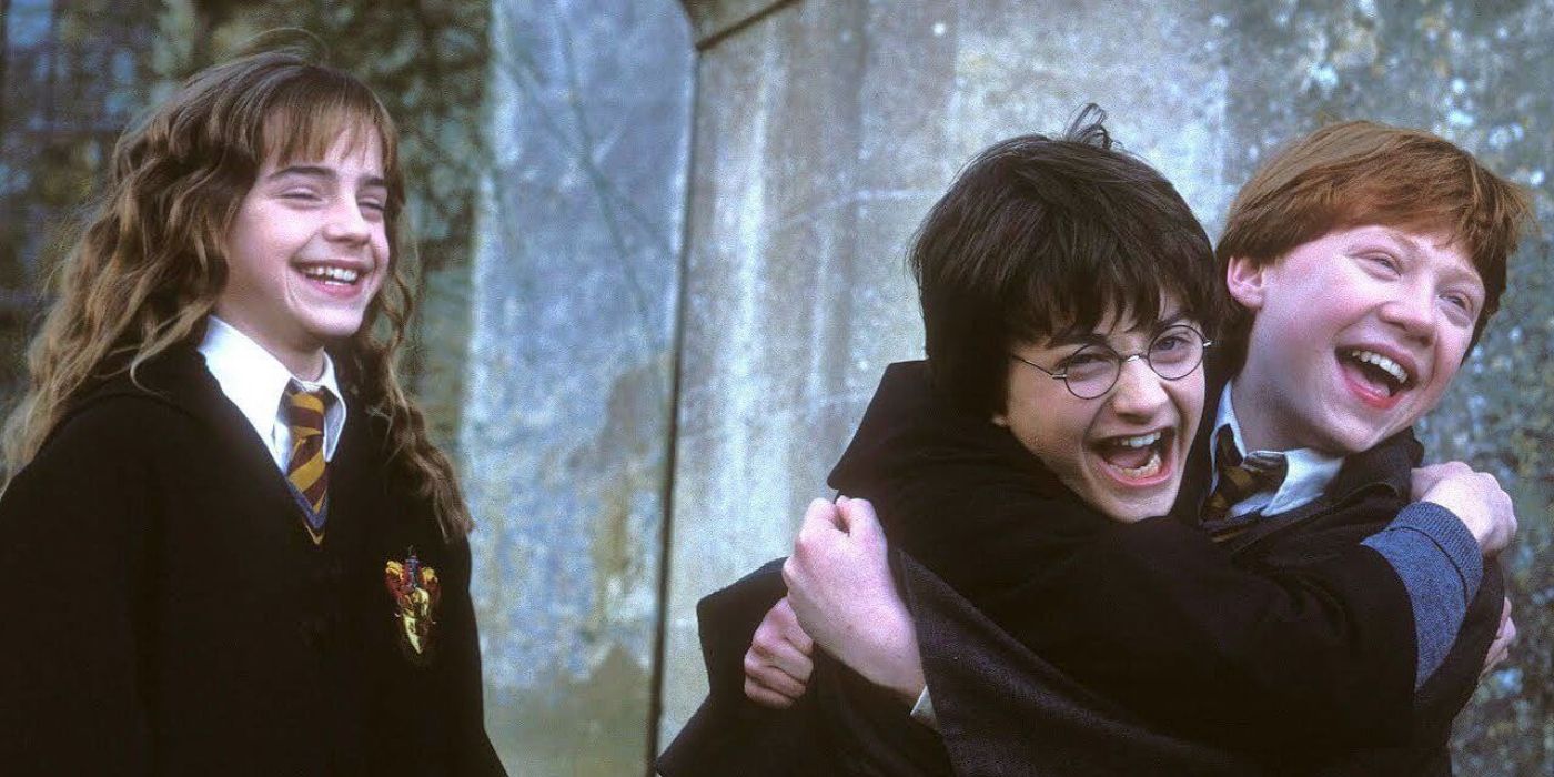 Hermione Granger laughing as Harry Potter and Ron Weasley hug