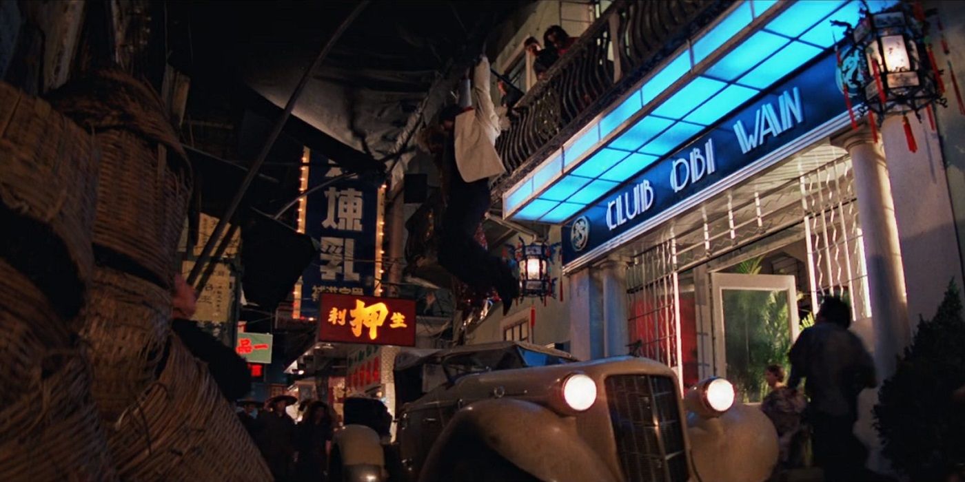 Club Obi-Wan on a crowded street with a blue neon light