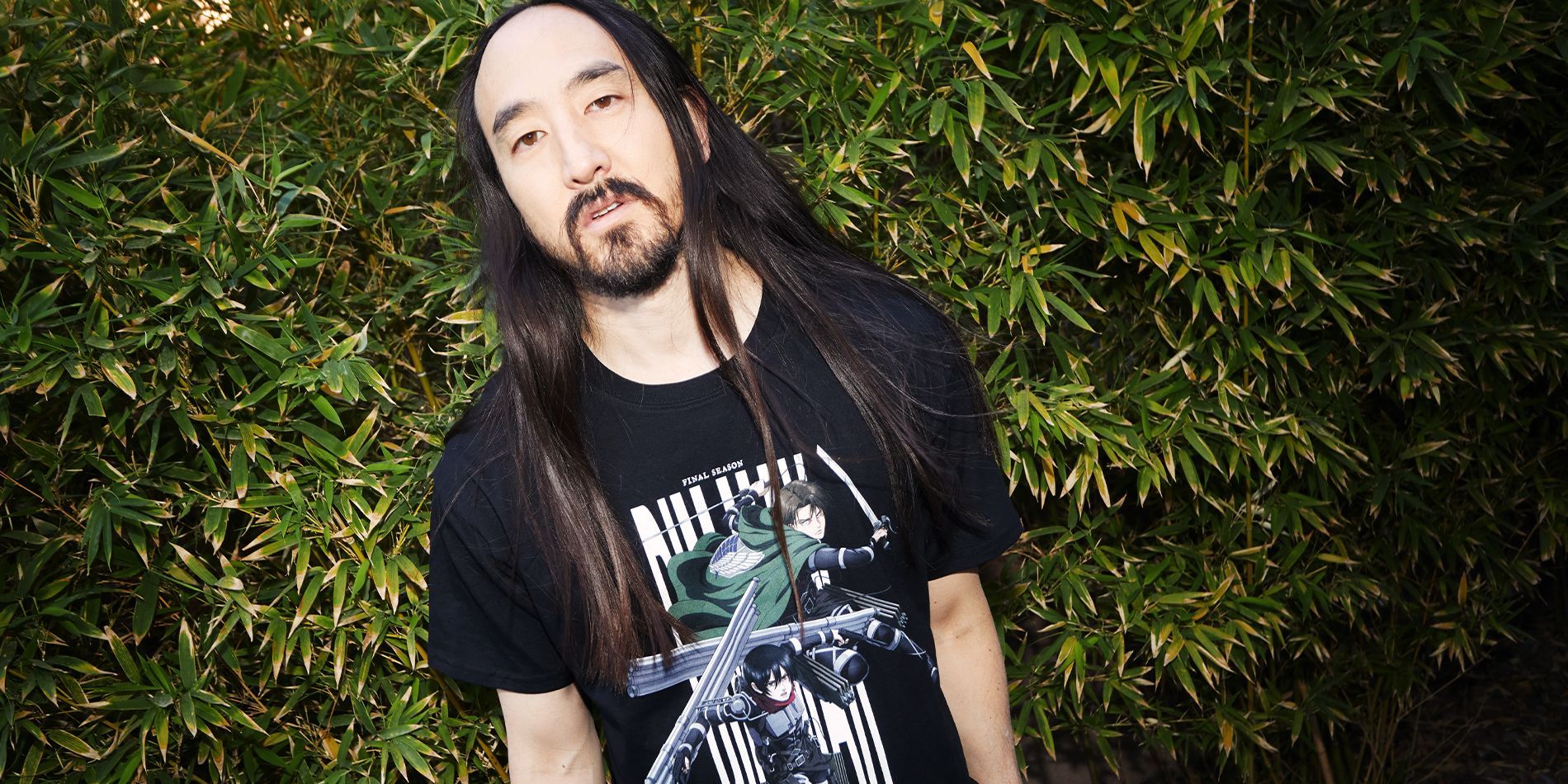 Steve Aoki modelling Levi and Mikasa black t-shirt from Din Mak Collection x Attack on Titan The Final Season Collaboration