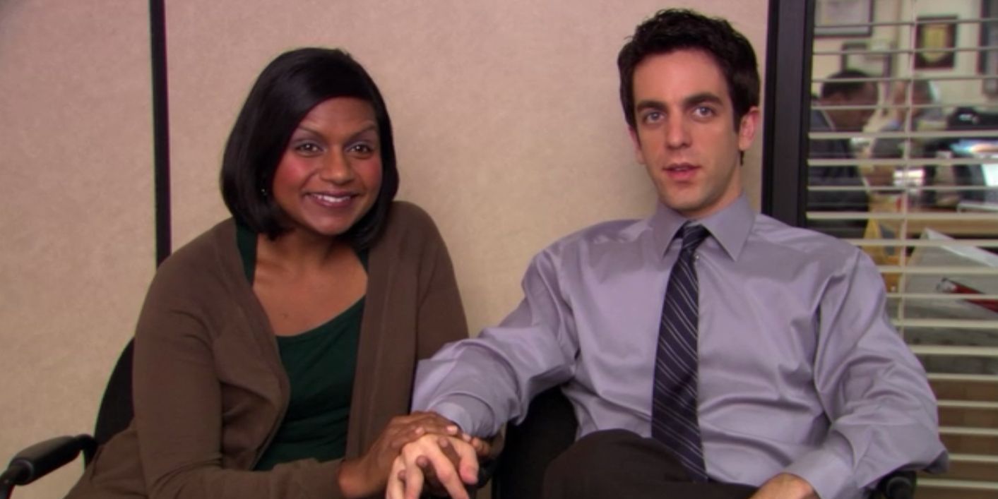 Kelly and Ryan holding hands in The Office