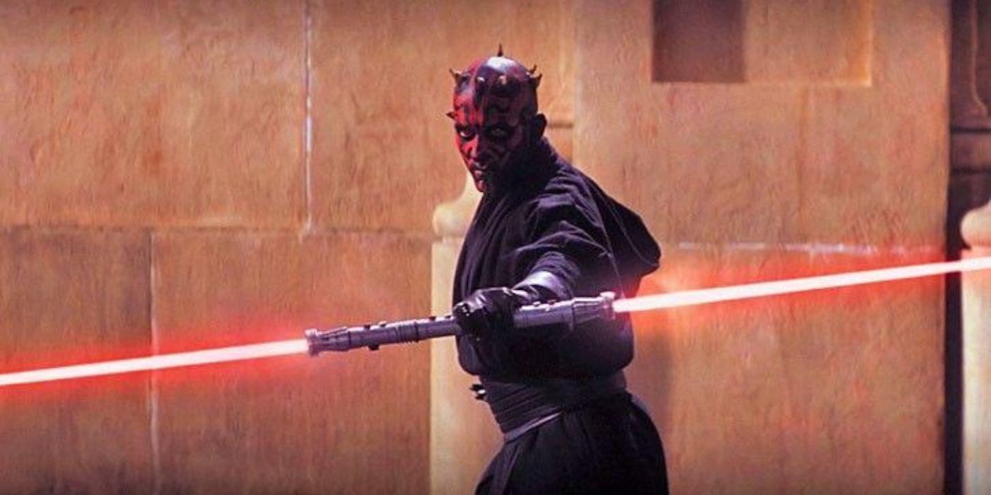 Sith Lord Darth Maul holds his double-bladed lightsaber in Star Wars The Phantom Menace.