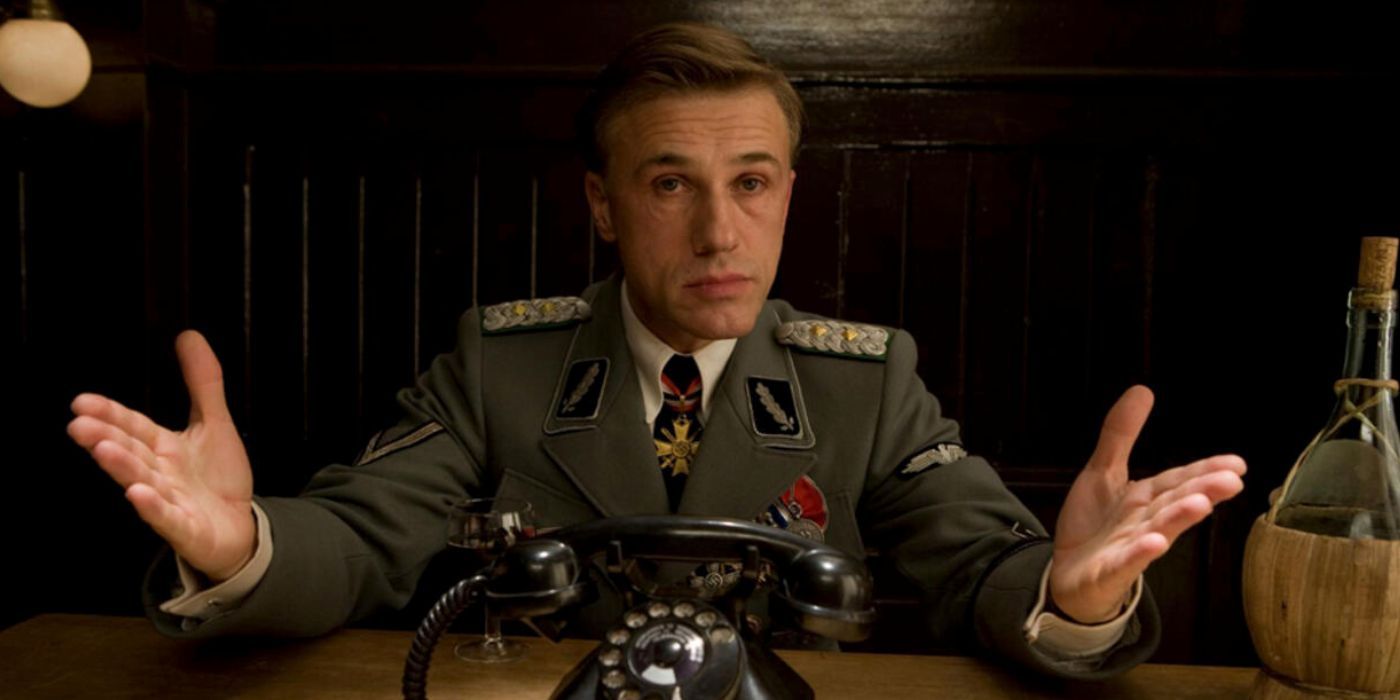 Hans Landa sitting at a table in the opening scene from Inglorious Basterds