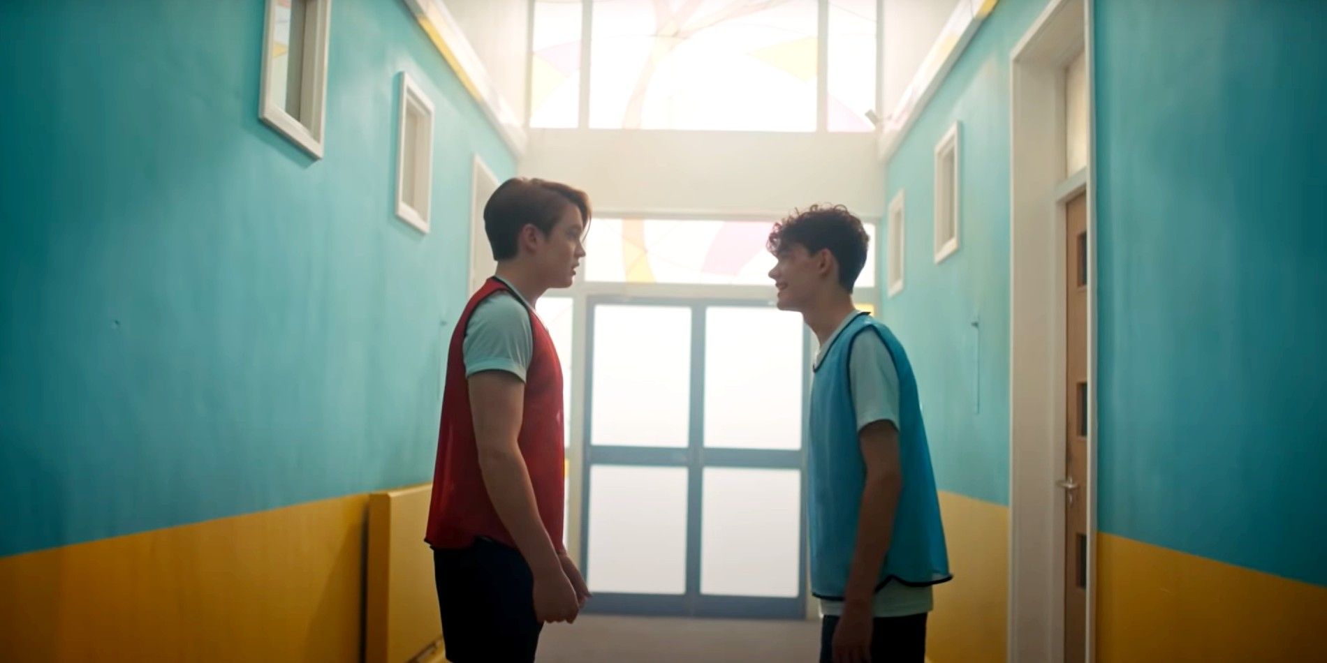 Nick and Charlie in the corridor on Sports Day in Heartstopper.