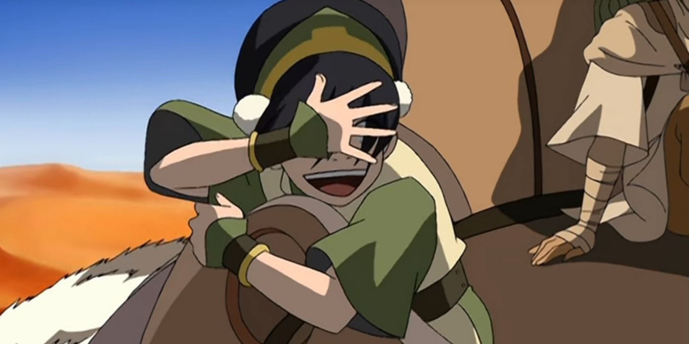 Toph balança a mão na frente do rosto para enfatizar sua cegueira em Avatar: O Último Mestre do Ar.