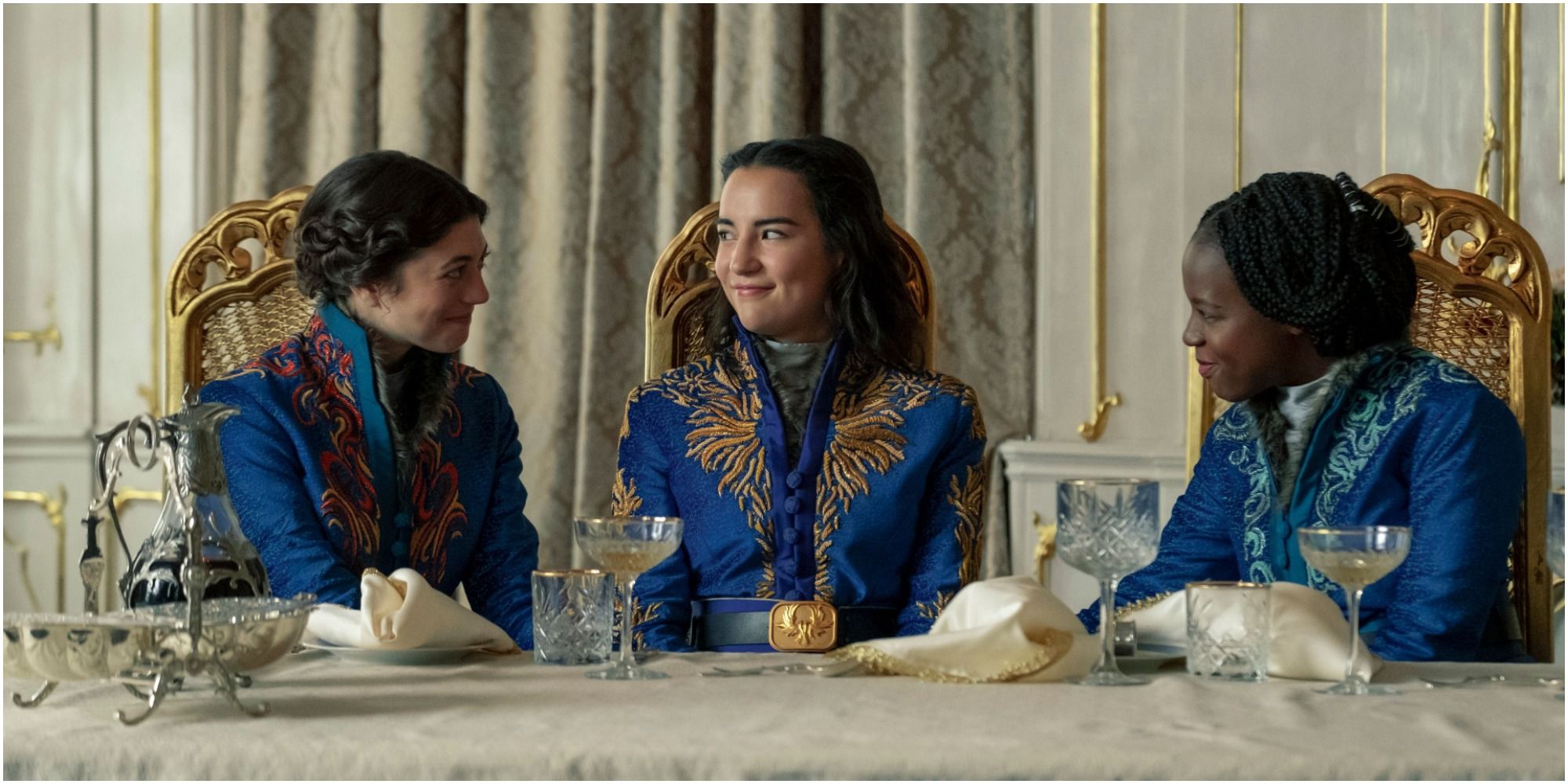 Alina and two other Grisha sit at a table