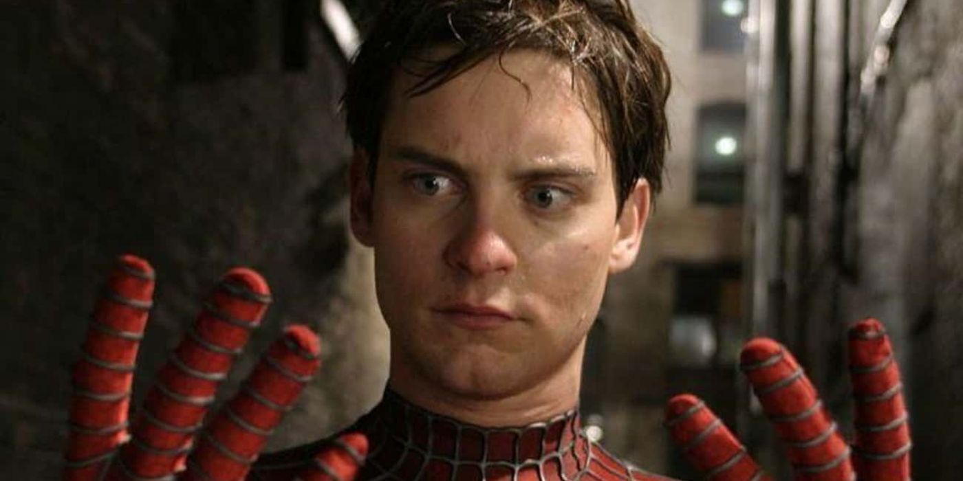 Tobey Maguire as Spider-Man looking at his hands