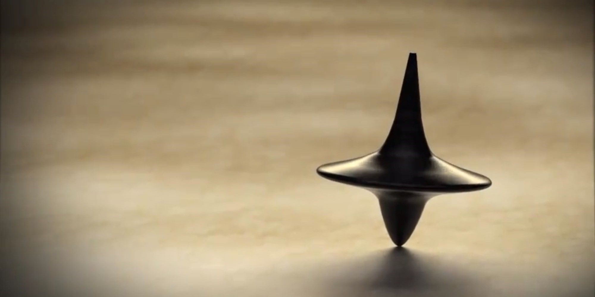 Inception 2010 film, directed by Christopher Nolan, image featuring spinning top totem