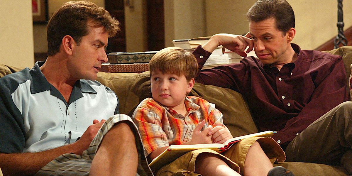 Alan, Charlie, and Jake sit on the couch together in Two And A Half Men