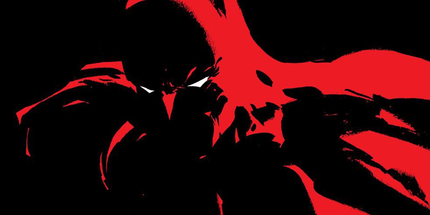 Batman's silhouette lit by neon red light in Dark Victory cover art.