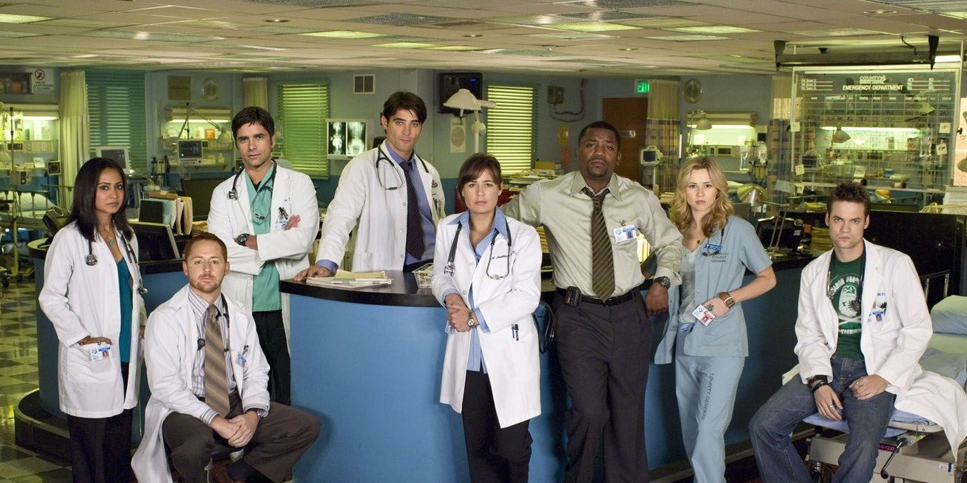 The cast of ER season 13 around the nurse's station of Cook County General Hospital