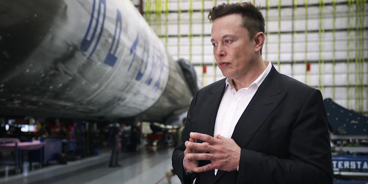 Elon Musk standing beside a rocket - Return to Space