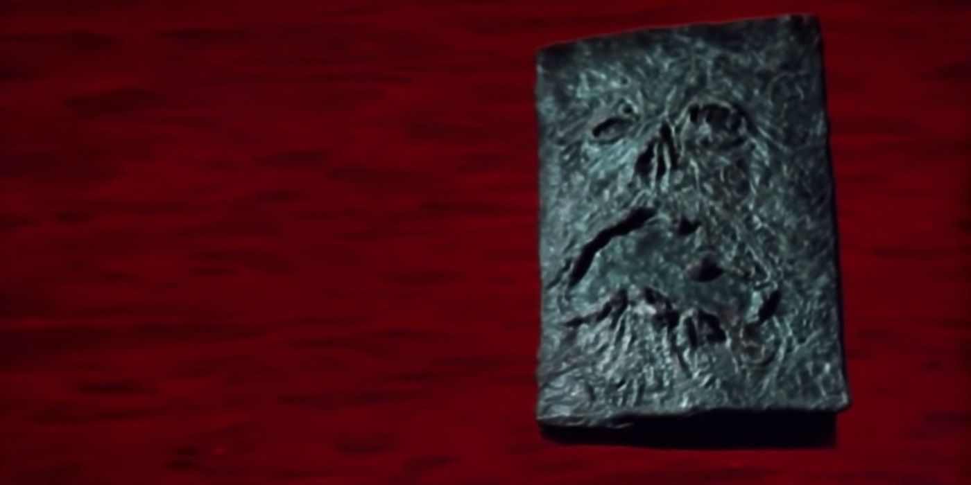 The Necronomicon against a red background in Evil Dead 2.