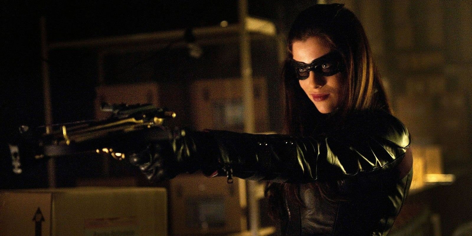 Huntress holding a gun and smiling in Arrow