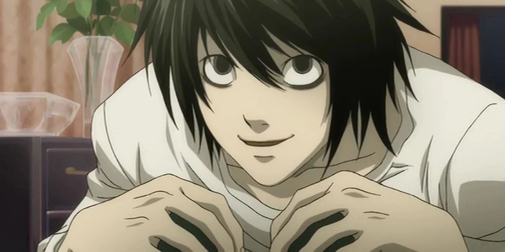 L with his hands on his knees in Death Note.