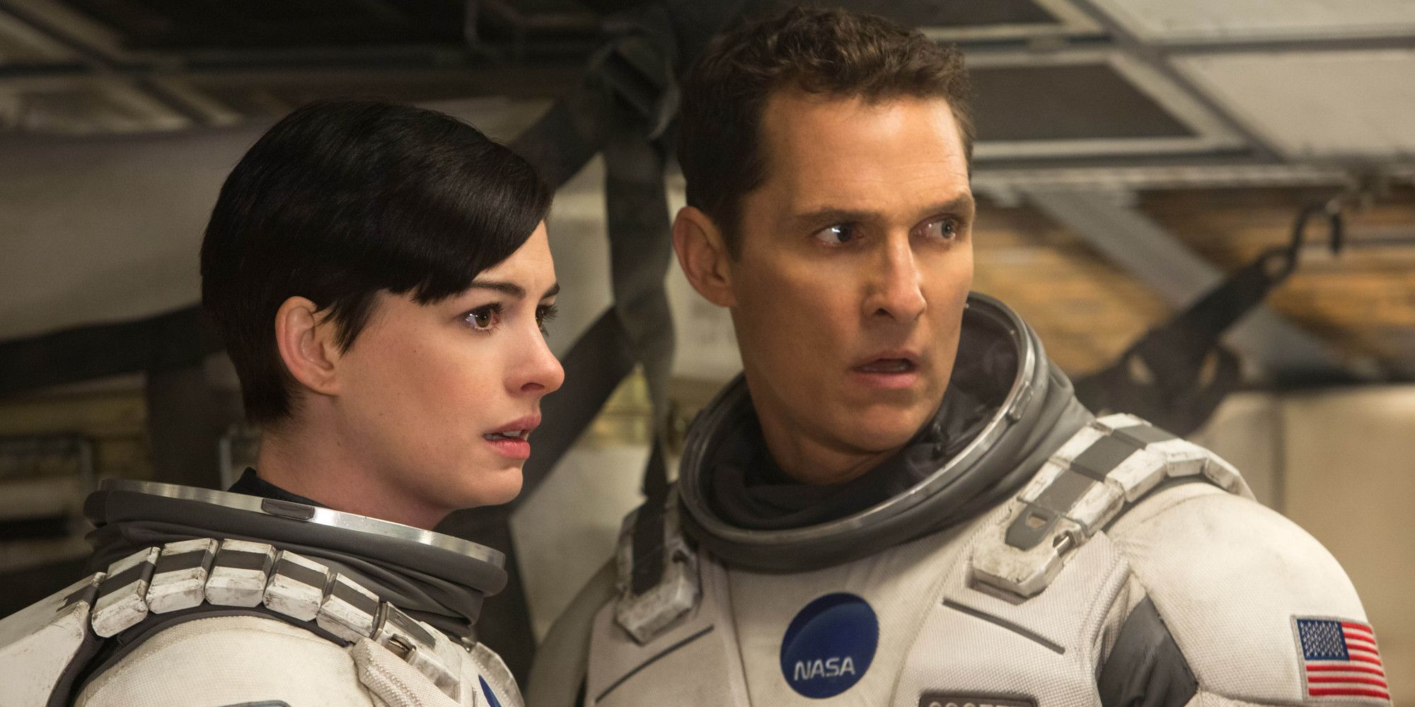 Anne Hathaway e Matthew Mcconaughey parecem preocupados enquanto usam trajes espaciais em Interestelar.