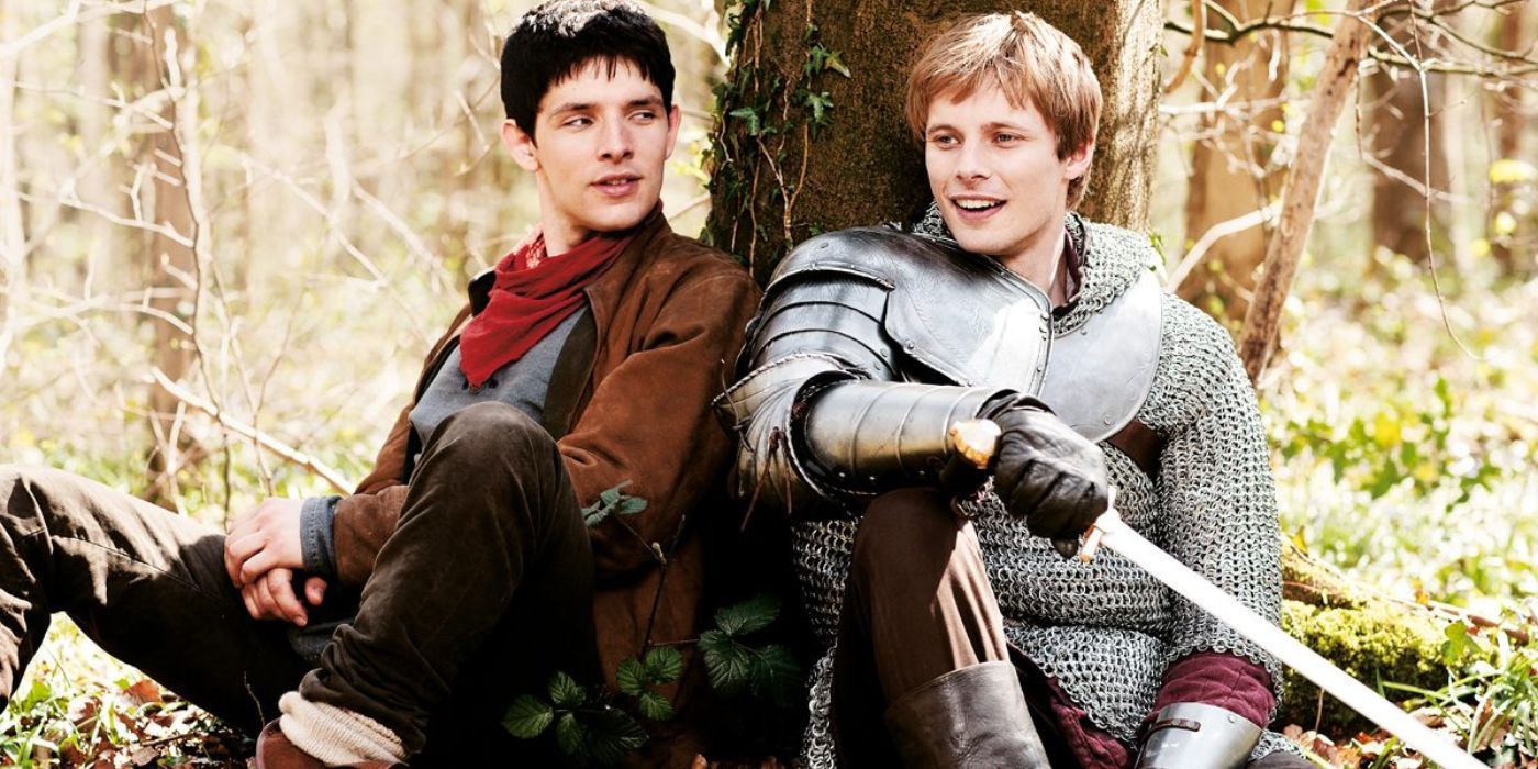 Merlin and Prince Arthur sitting on a tree in Merlin.