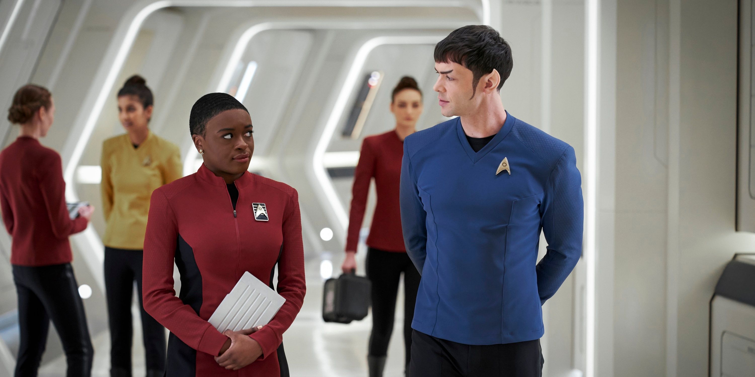 Celia Rose Gooding as Uhura and Ethan Peck as Spock walk the Enterprise in the Paramount+ original series Strange New Worlds.