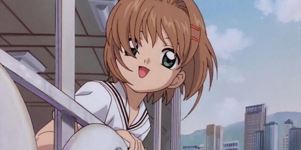 Sakura smiling while hanging out a school bus window in Cardcaptor Sakura.