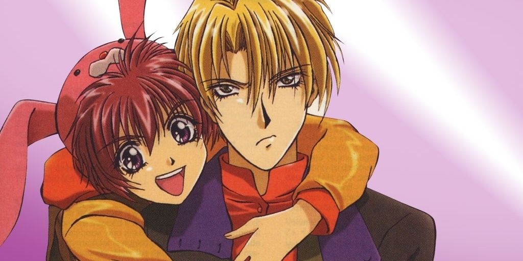 Shuichi Shindou and Eiri Yuki hugging in front of a shiny pink background in Gravitation.