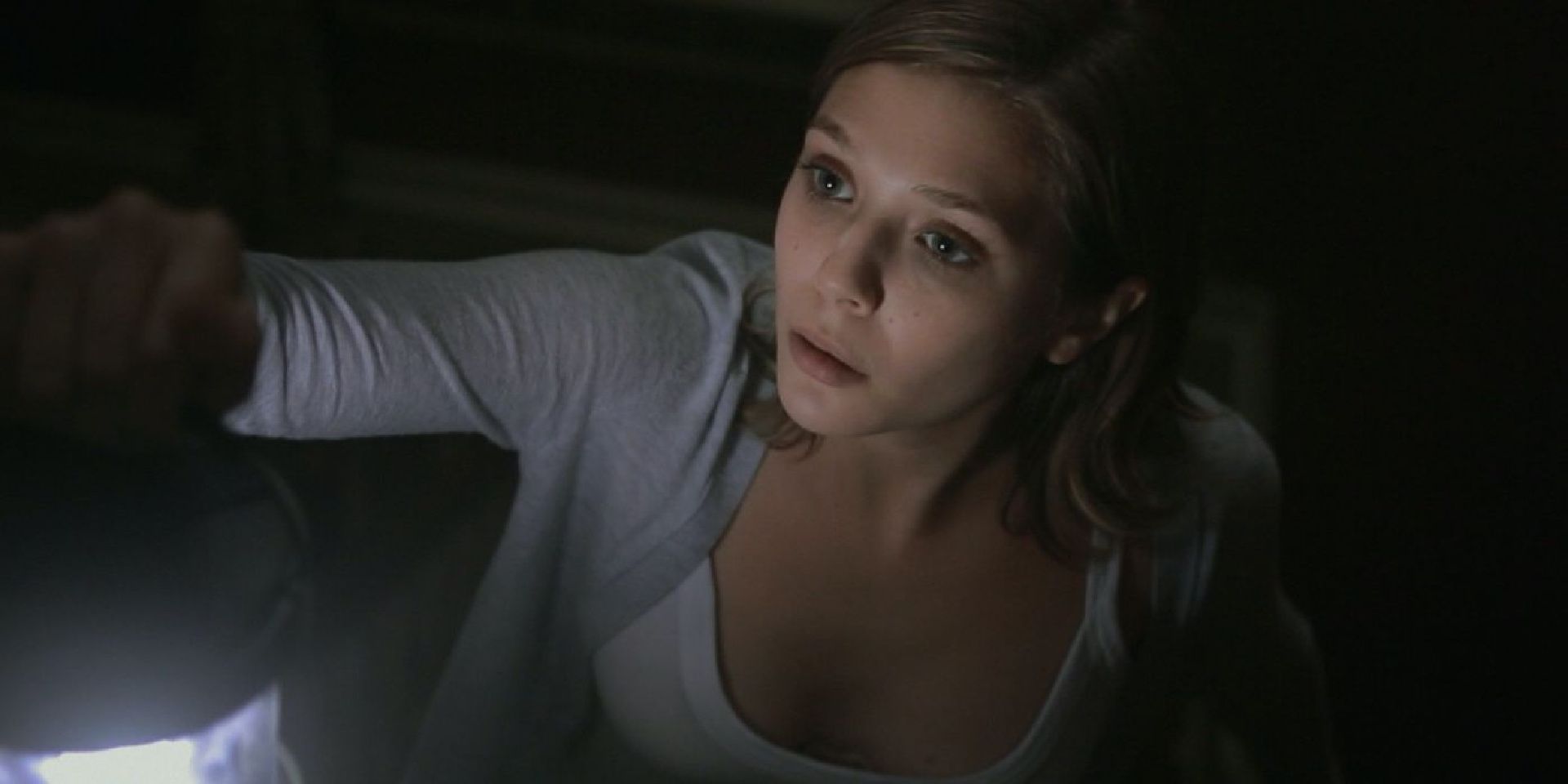 Sarah uses a lantern during a black out in the horror film Silent House