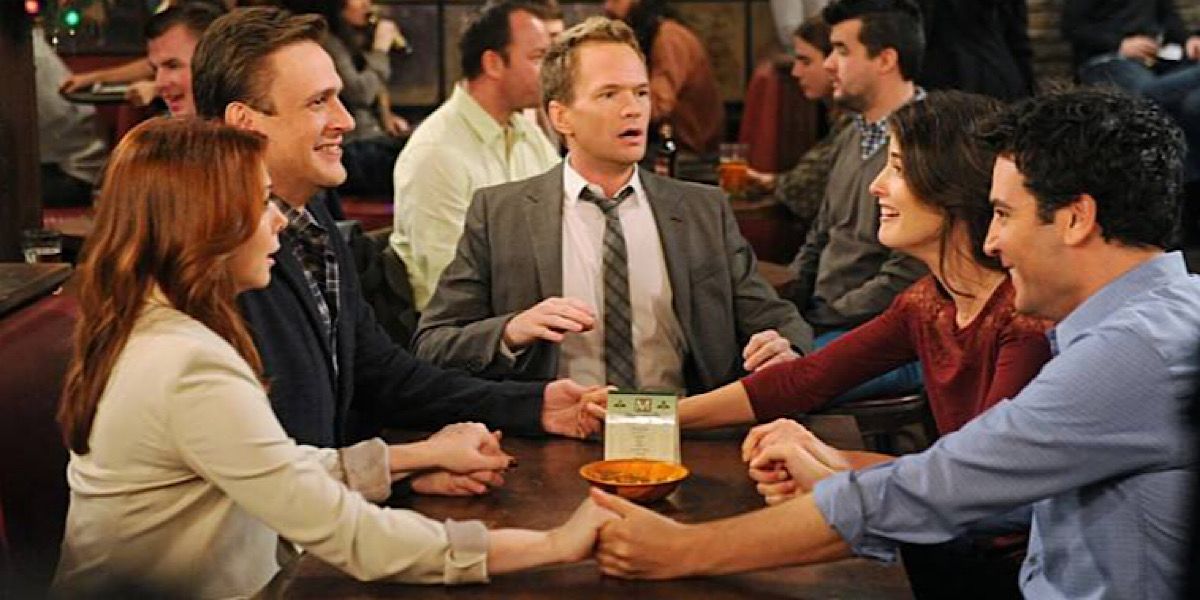 Ted, Lily, Robin, Marshall, and Barney holding hands around the table - How I Met Your Mother