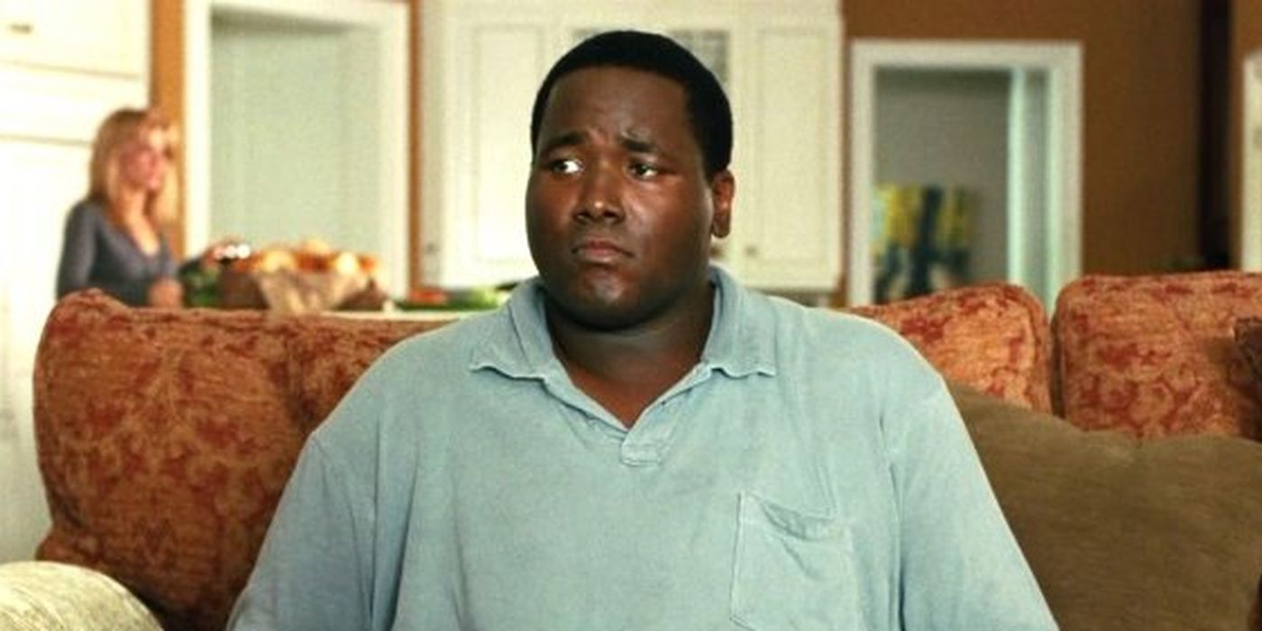 Quentin Aaron as Michael Oher sitting on a couch in The Blind Side