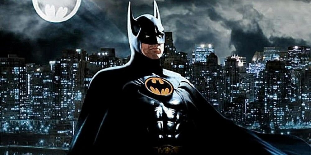 Michael Keaton as Batman, posing in front of the Gotham City skyline in Batman (1989)
