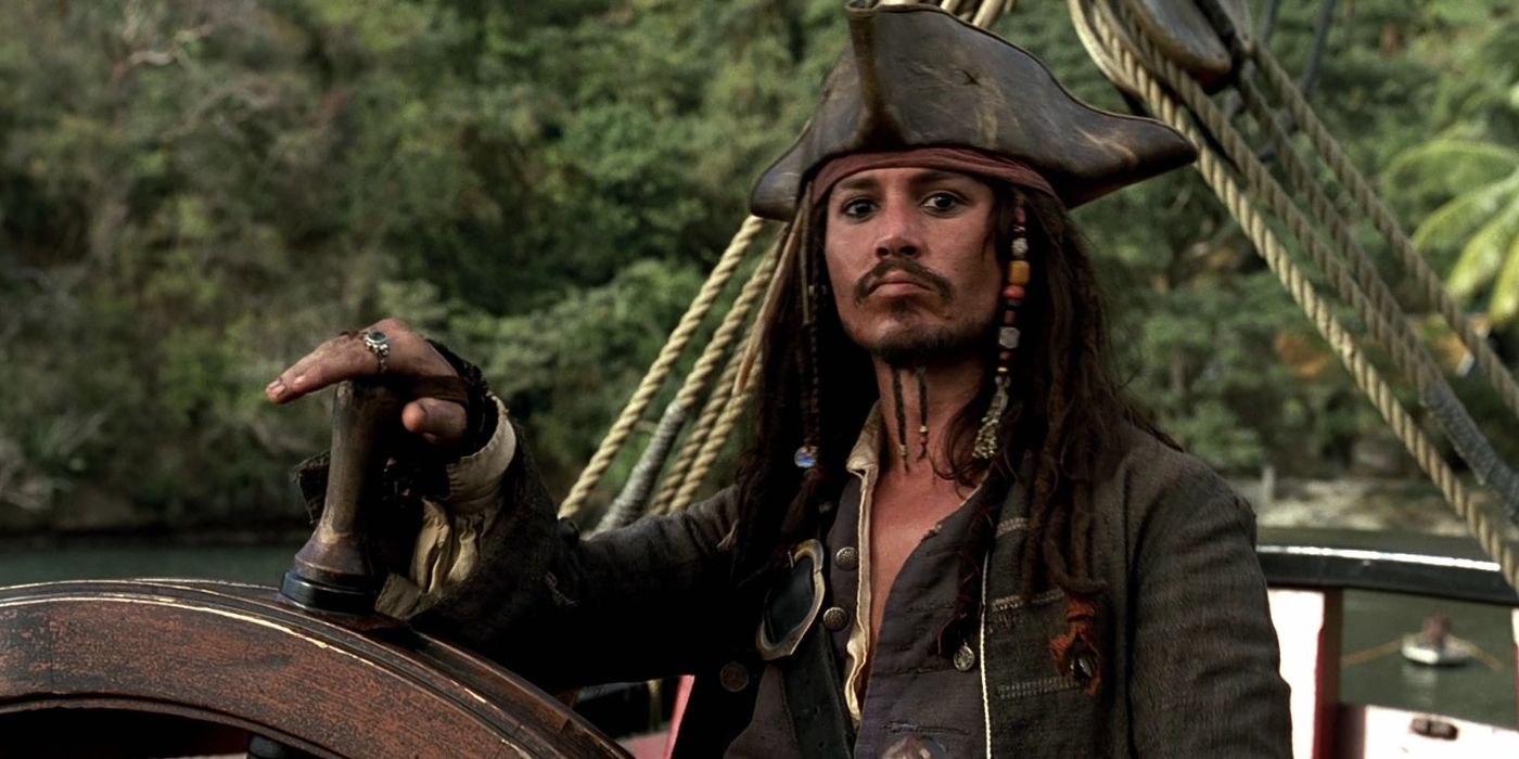 Jack Sparrow with his hand on the wheel in Pirates of the Caribbean: Curse of the Black Pearl.