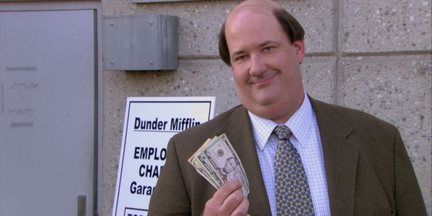 Kevin Malone, played by Brian Baumgartner, holding money and looking smug in The Office