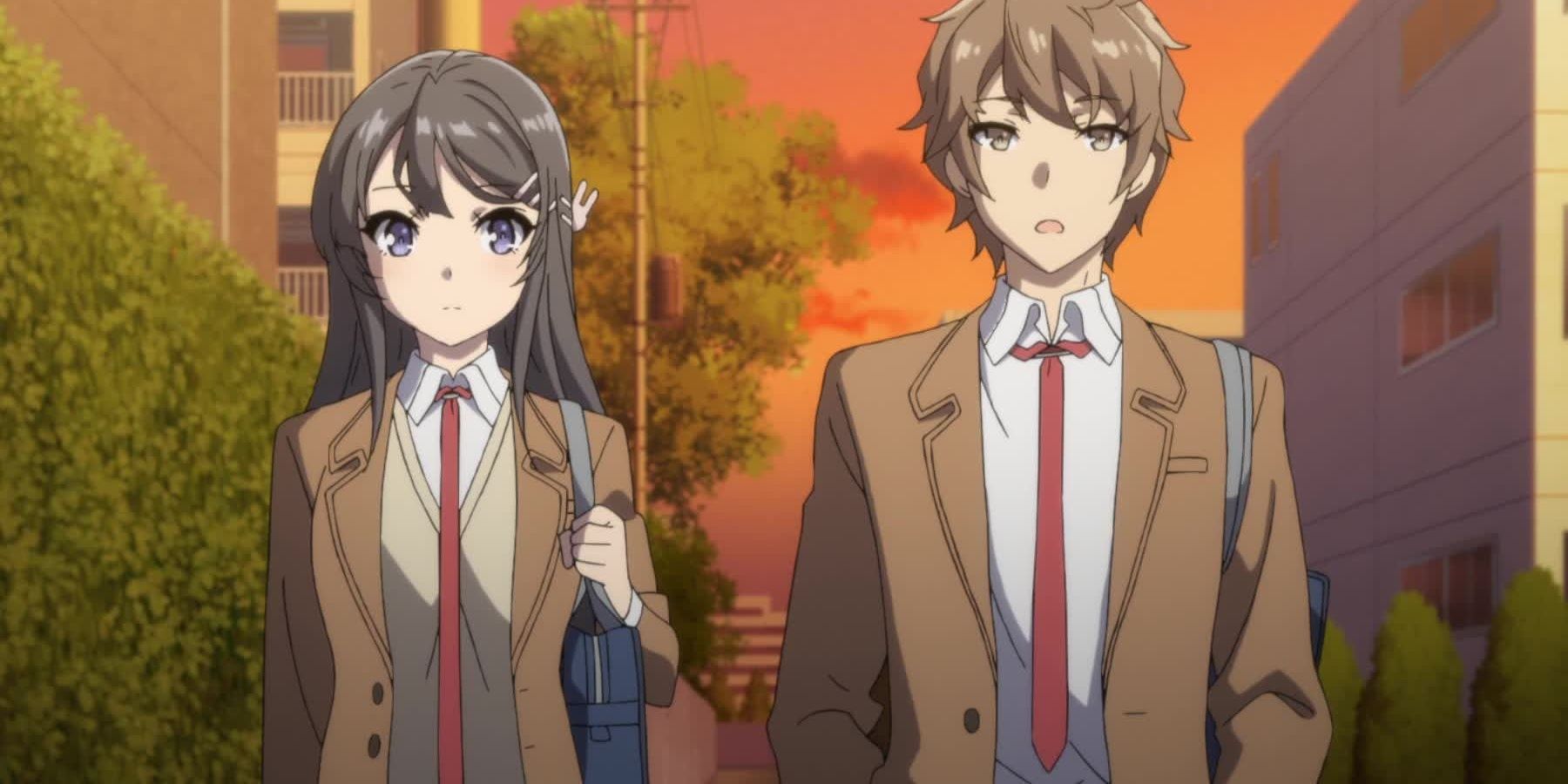 Sakuta and Mai stand side by side in their school uniforms in the evening