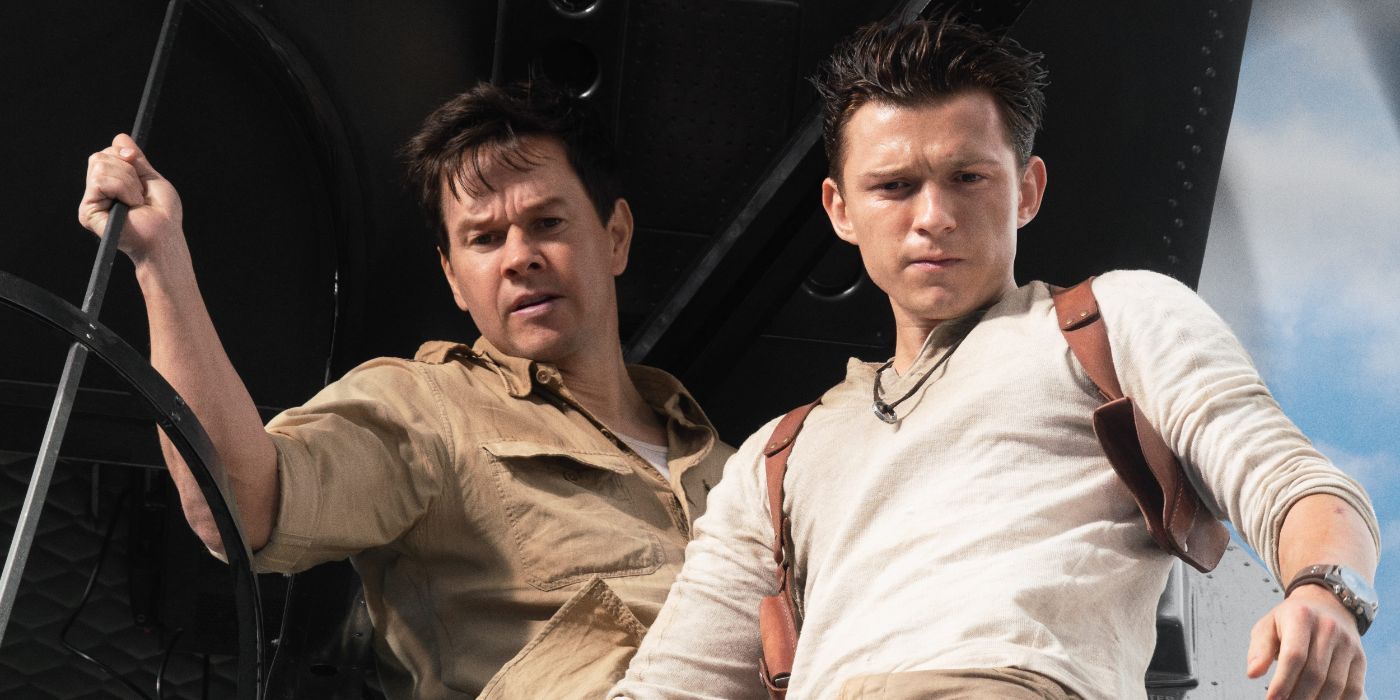 Sully (Mark Wahlberg) and Nathan Drake (Tom Holland) looking out of a cargo plane in Uncharted