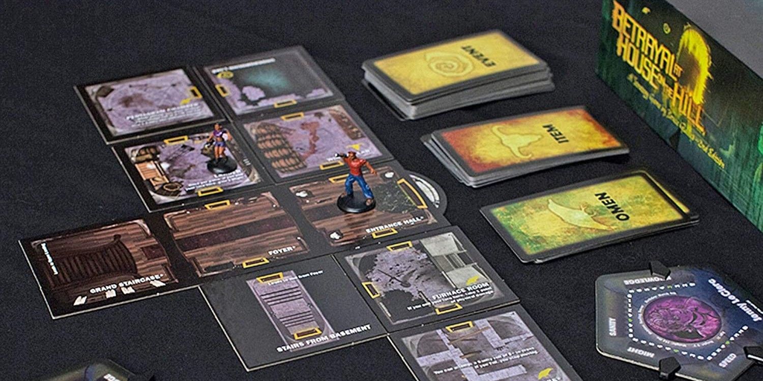 Several board tiles, cards, and miniatures for Betrayal at House on the Hill.