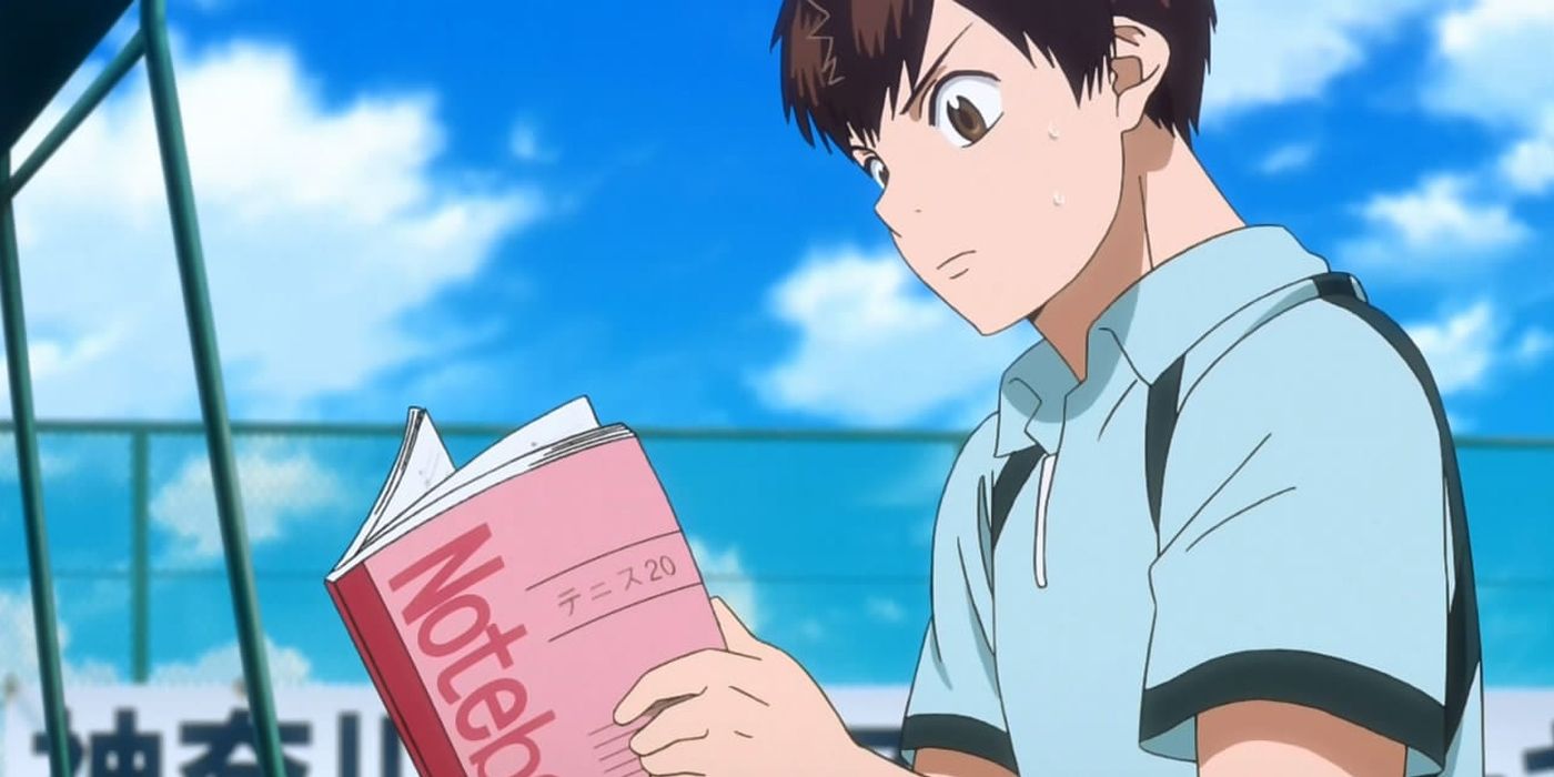 Eiichiro reading his notebook