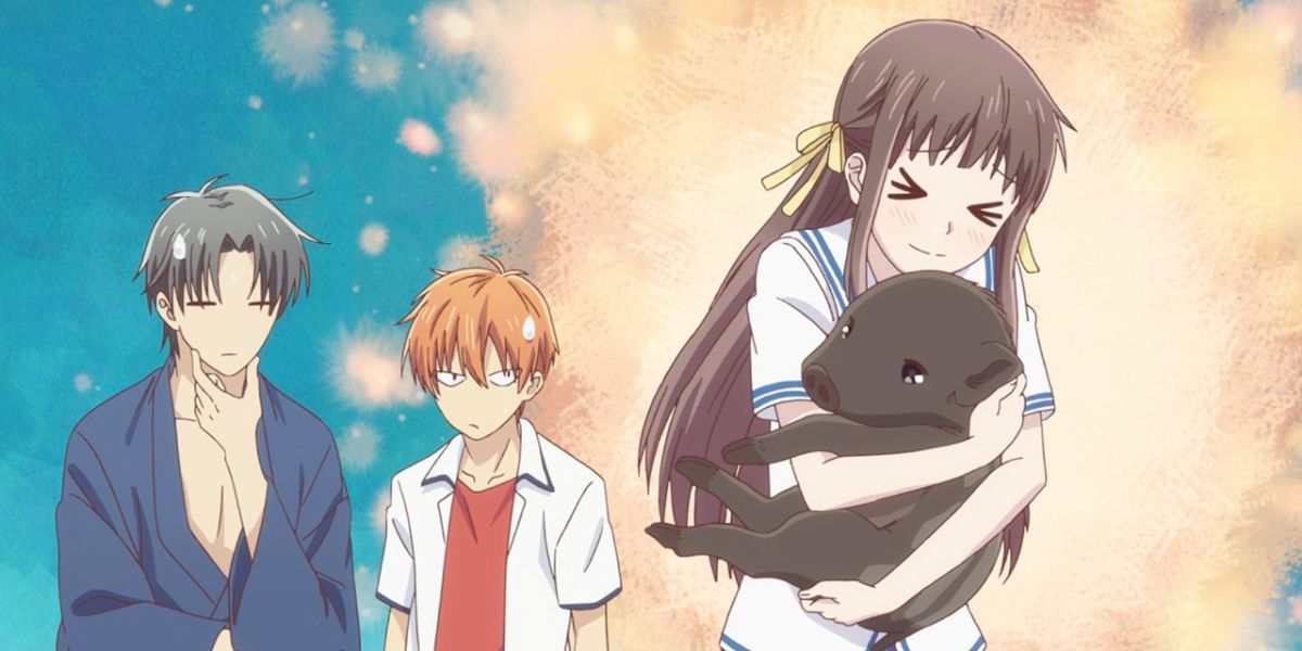 Image features a visual from Fruits Basket: (From left to right) Shigure Sohma (short, black hair and dark blue kimono) has his hand on his chin, Kyo Sohma (short, orange hair and white and red shirt) is looking away with an anime sweat drop on his head, and Tohru Honda (long, brown hair, yellow ribbons, and blue and white school uniform) is hugging Kagura Sohma (small black boar).
