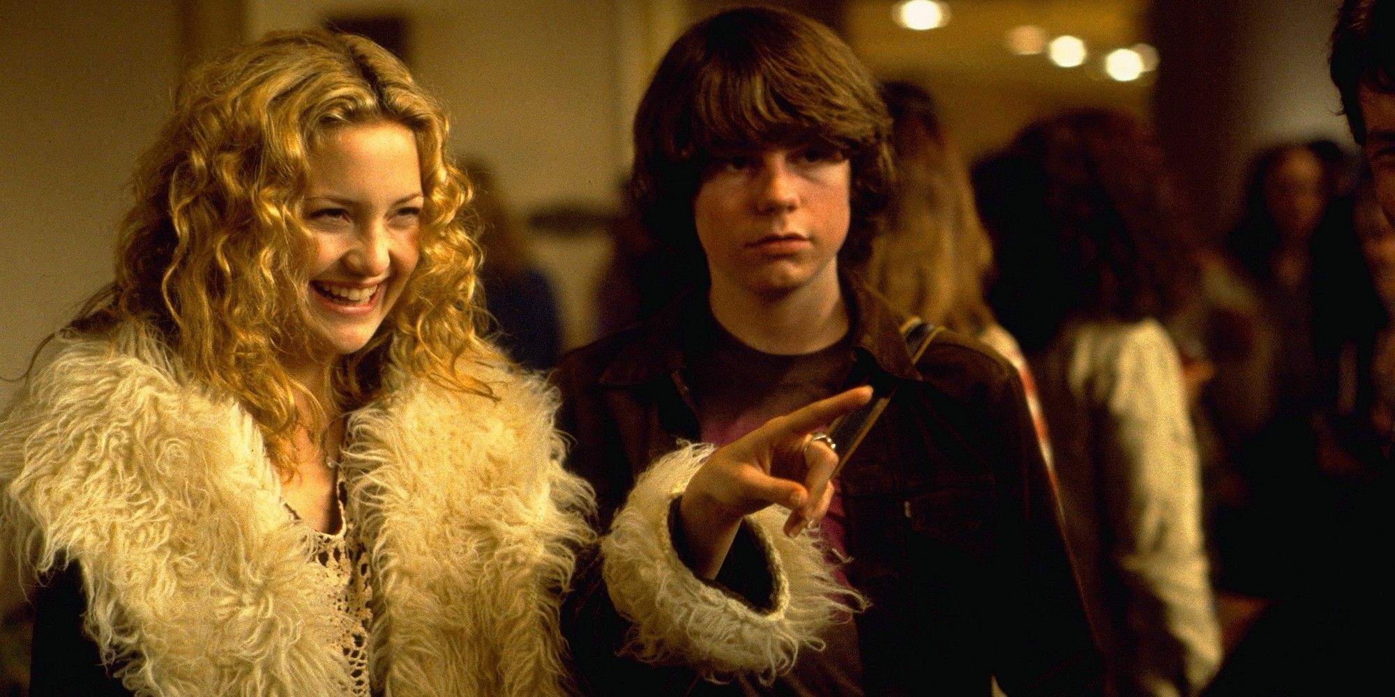 Kate Hudson's Penny Lane points and smiles as Patrick Fugit's William looks stoic in Almost Famous