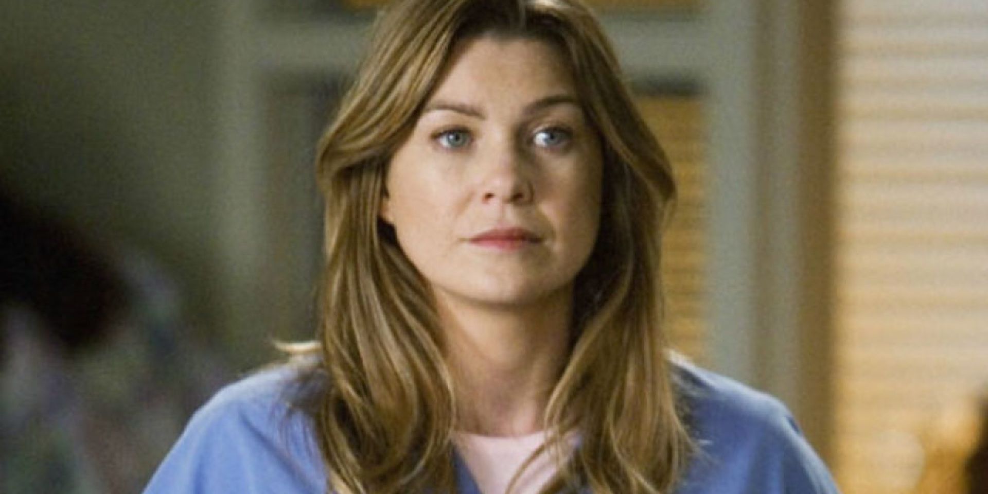 Meredith Grey stands in the hallway on Grey's Anatomy