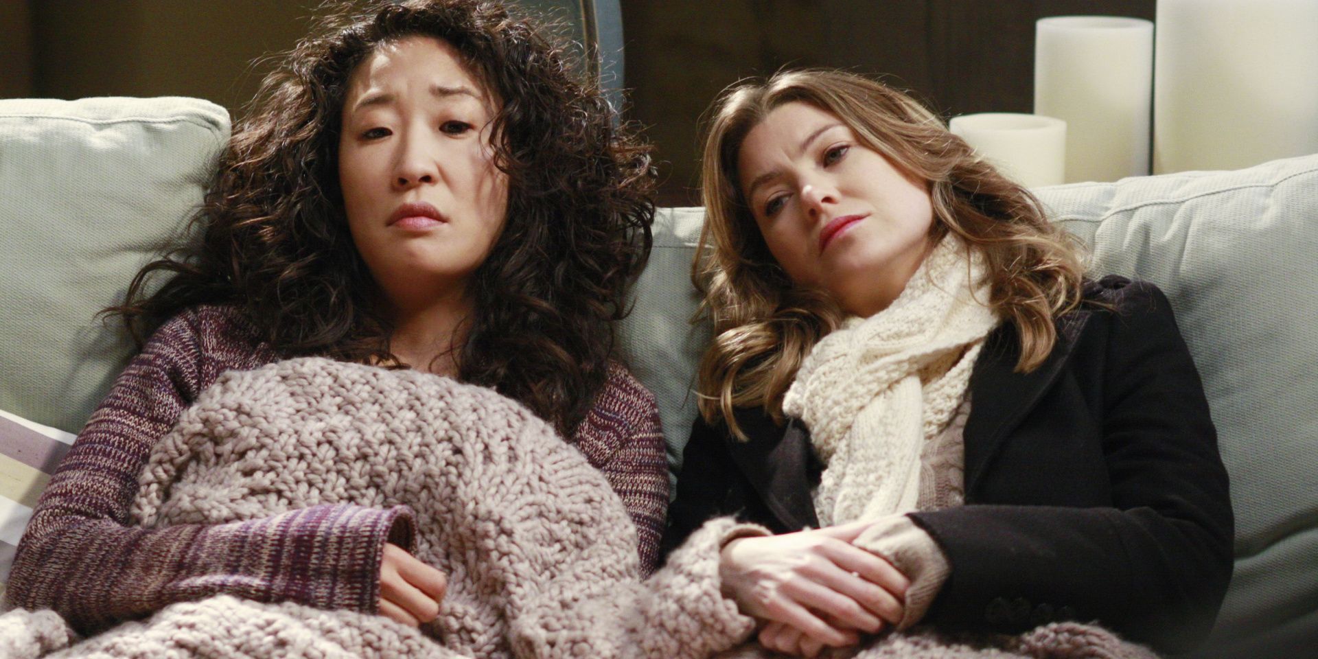 Meredith and Cristina lay on the couch in Grey's Anatomy