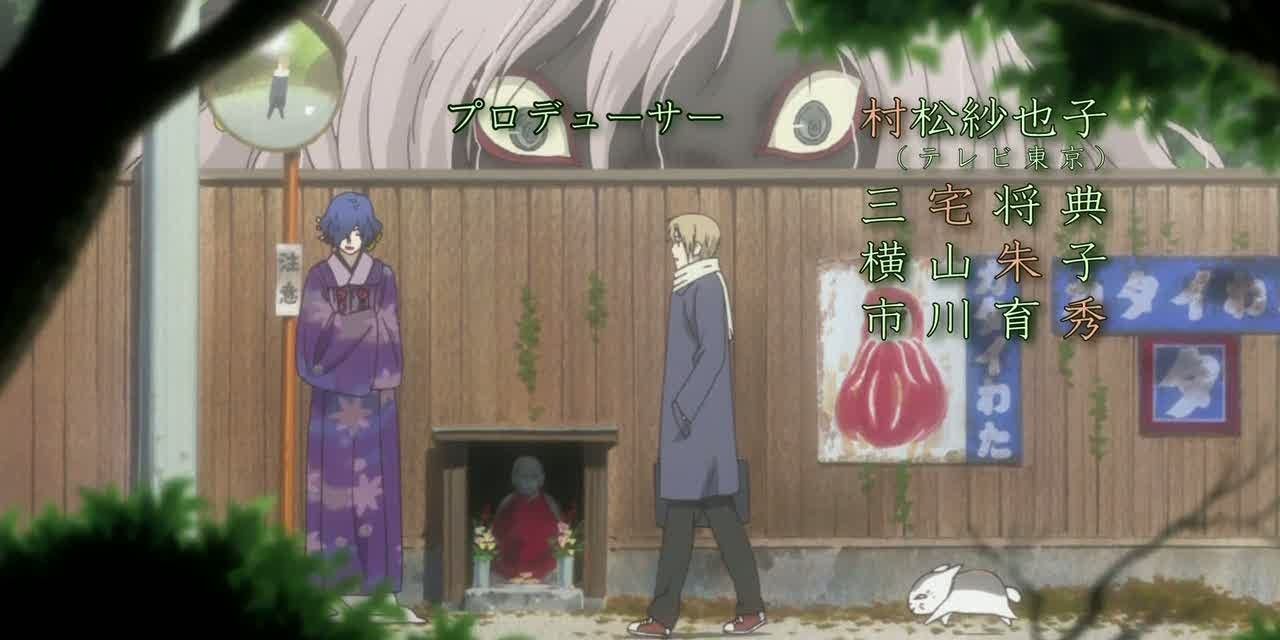 Natsume and Nyanko walking in a street with yokai