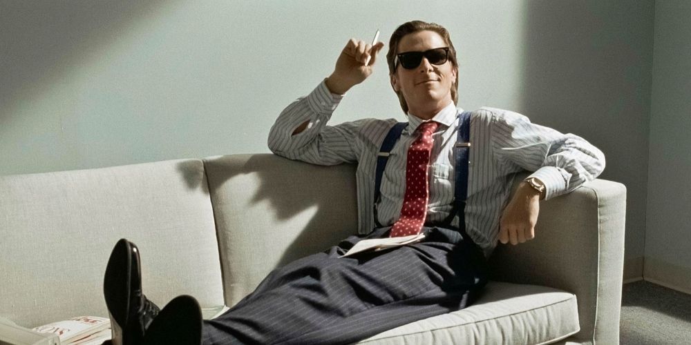 Patrick Bateman laying on a couch in American Psycho