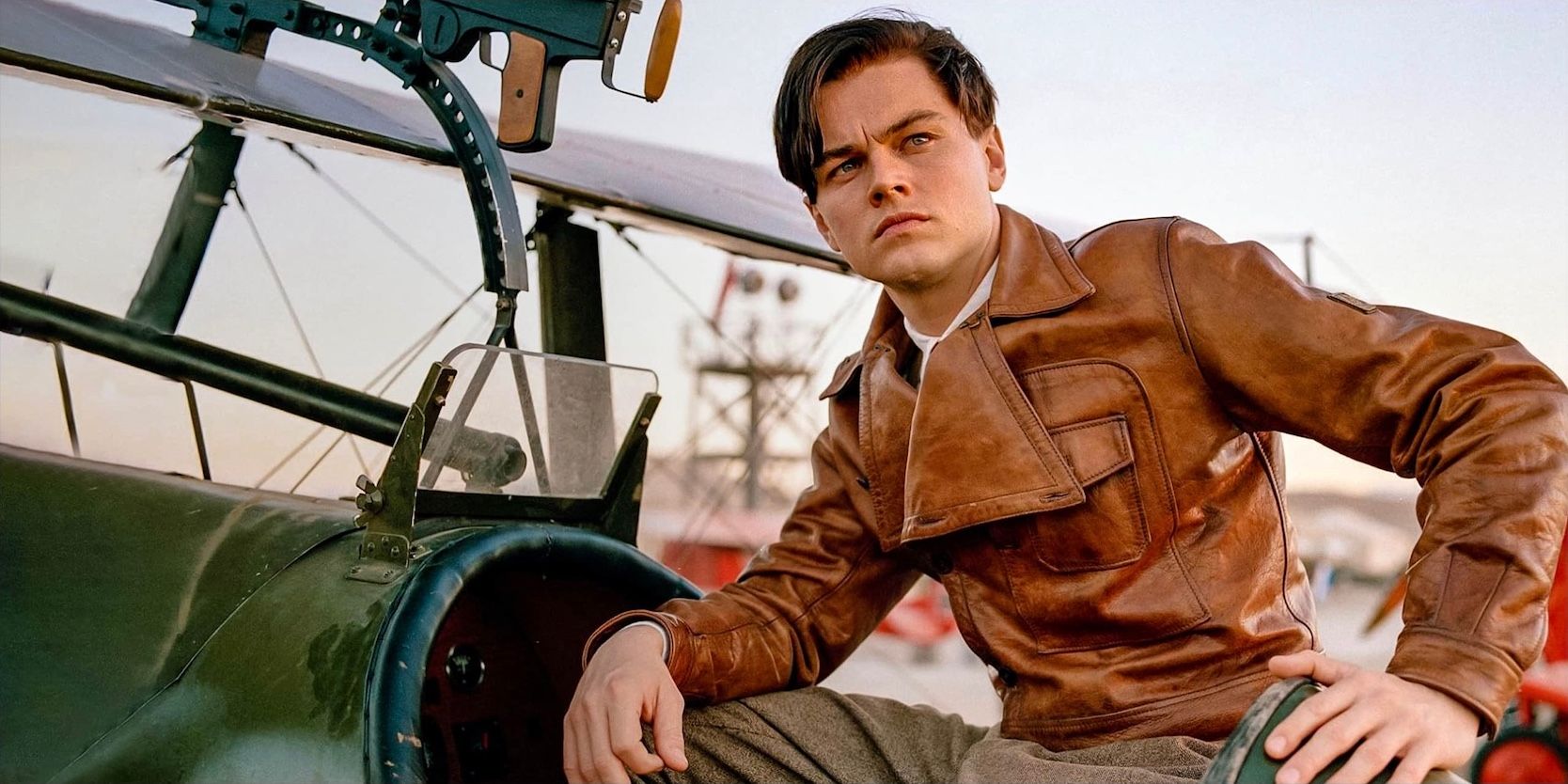 Leonardo DiCaprio poses against a plane in The Aviator