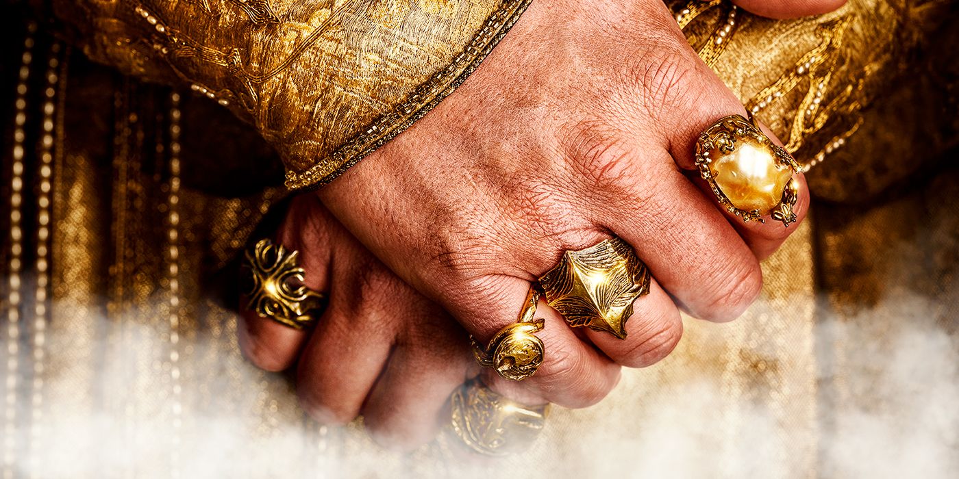 An image of a man's hand, wearing many rings, from Prime's Rings of Power