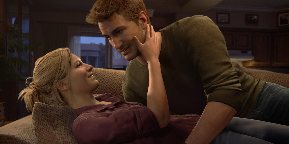 Elena and Nathan Drake embrace on the couch in Uncharted 4