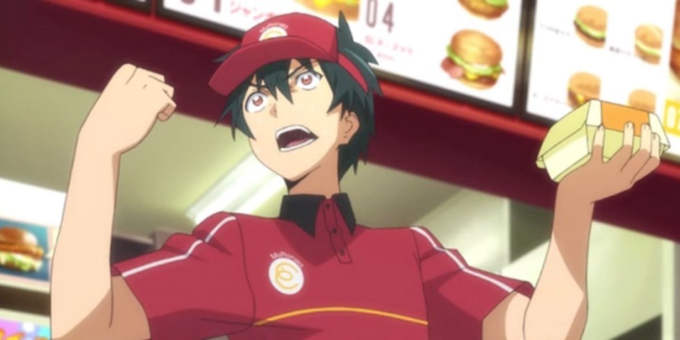 Sadao in The Devil Is A Part-Timer holding a burger with clenched fist.