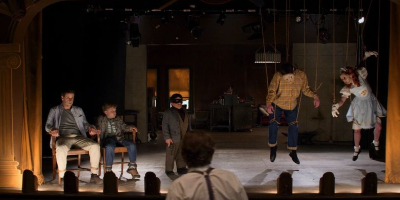 Five people on a stage, two strung up as marionettes and one dressed as a robber, Criminal Minds