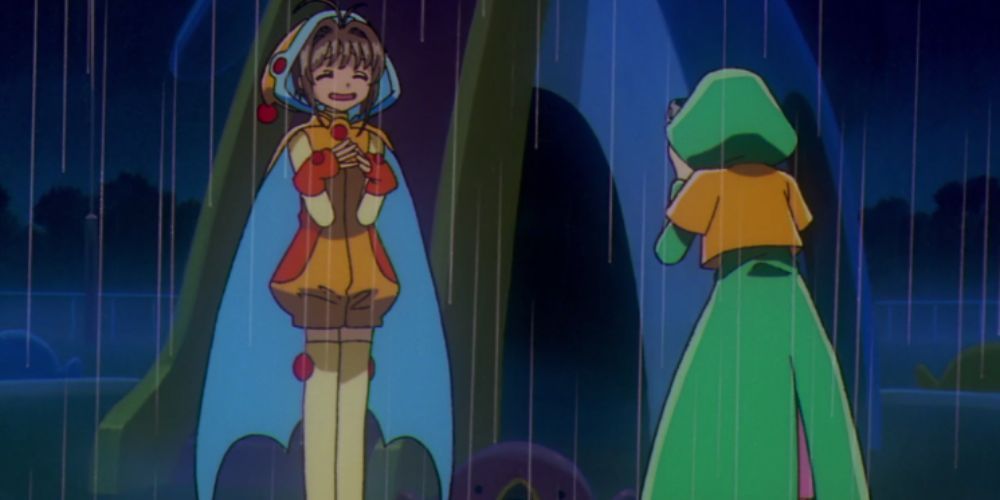Cardcaptor Sakura stands in the rain smiling for the camera in Cardcaptor Sakura.