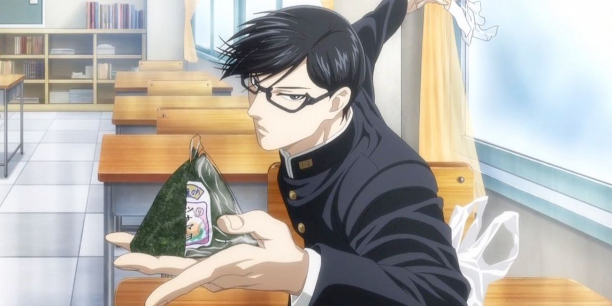 Sakamoto holds an onigiri while posing in Haven't You Heard? I'm Sakamoto.