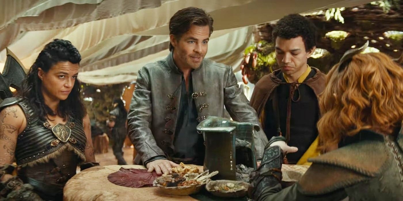 Michelle Rodriguez, Chris Pine and Justice Smith standing around a table in Dungeons and Dragons: Honor Among Thieves