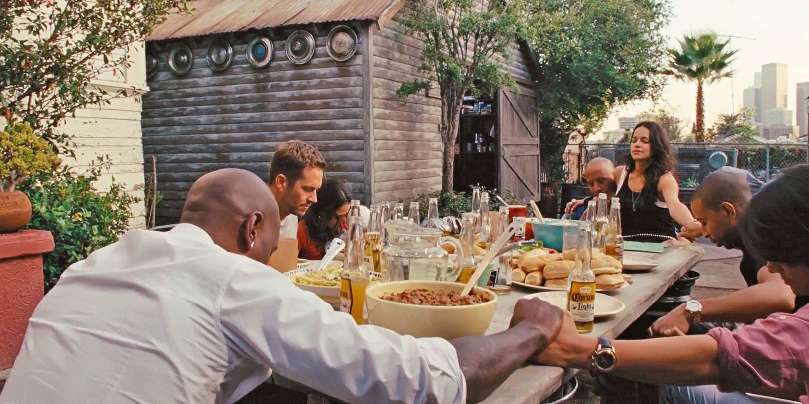 Cast of Fast and Furious 6 saying grace around the dinner table. 